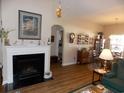 Inviting living room featuring a cozy fireplace, warm wood floors, and stylish decor at 741 Londonberry Ct., Conway, SC 29526