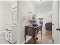 Hallway with a charming table leading to a full bathroom and living room at 1673 Middleton St., Georgetown, SC 29440