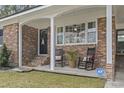 Inviting covered porch with rocking chairs and brick columns and ADT security system at 1673 Middleton St., Georgetown, SC 29440