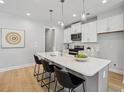 Modern kitchen with white cabinets, stainless steel appliances, and a quartz countertop island at 2400 Hillbourne Loop, North Myrtle Beach, SC 29582