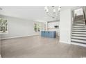 Spacious living area showcasing hardwood floors, abundant natural light, and a modern kitchen with island at 2620 Hillbourne Loop, North Myrtle Beach, SC 29582