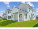 View of a covered back porch with blue ceiling, and an adjoining grass yard at 2628 Hillbourne Loop, North Myrtle Beach, SC 29582