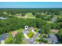 Aerial view of a home located on a golf course in a wooded neighborhood at 765 Ashley Manor Dr., Longs, SC 29568