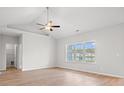 Serene bedroom with a vaulted ceiling, large window overlooking a pond, and a ceiling fan at 1209 Cypress Shoal Dr., Conway, SC 29526