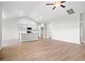 Bright open-concept living space flows into the kitchen, featuring hardwood floors and modern finishes at 1209 Cypress Shoal Dr., Conway, SC 29526