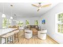 Open-concept living room with modern furnishings, light wood floors, and sliding glass doors to the outside at 210 26Th Ave. S, Myrtle Beach, SC 29577