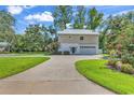 Charming home with a metal roof, a spacious driveway, and lush landscaping at 613 Lee Ave., Murrells Inlet, SC 29576