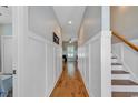 Welcoming hallway featuring hardwood floors, wainscoting, and staircase at 613 Lee Ave., Murrells Inlet, SC 29576