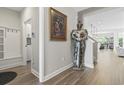 Hallway featuring wood-look flooring and opening to a kitchen, dining and living area at 7246 Sarteano Dr., Myrtle Beach, SC 29572
