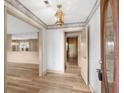 Inviting entryway featuring wood-look floors, decorative wall trim, and a stylish pendant light at 74 Brandy Ln., Georgetown, SC 29440