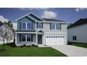 Inviting two-story house featuring blue and gray siding, dark shutters, and an attached two-car garage at 896 Agostino Dr., Myrtle Beach, SC 29579
