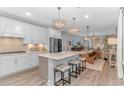 Modern kitchen with white cabinets, quartz countertops, and an island at 1518 Littleleaf Loop, North Myrtle Beach, SC 29582