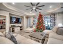 Spacious living room features a ceiling fan, recessed lights, luxury vinyl flooring, and a decorated Christmas tree at 2023 Singing Palm Loop, Little River, SC 29566