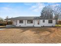 A single-story home has a brick exterior and dark trim, with a small front yard and driveway at 412 E Melrose St., Mullins, SC 29574