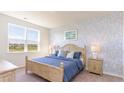 Comfortable bedroom with a blue-themed decor and large windows offering natural light at 210 Carver Willow Dr., Loris, SC 29569