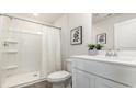 Clean bathroom with a walk-in shower, white vanity, and modern fixtures at 218 Carver Willow Dr., Loris, SC 29569