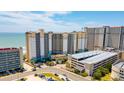 Expansive aerial view of resort buildings, parking garage, and oceanfront location with beach access at 4800 S Ocean Blvd. # 920, North Myrtle Beach, SC 29582