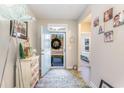 Inviting home foyer with natural light, tile flooring, and charming decor, as well as direct bedroom access at 5037 Sassari St., Myrtle Beach, SC 29579