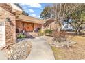 Beautiful brick home featuring a manicured front yard, mature landscaping, and a welcoming entryway at 512 N Myrtle Dr., Surfside Beach, SC 29575