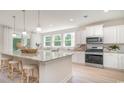 Modern kitchen with granite countertops, stainless steel appliances, and a large island with bar seating at 562 Haven View Way, Murrells Inlet, SC 29576