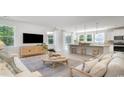 Open-concept living space with modern furniture, a cozy seating area, and seamless flow to the kitchen at 562 Haven View Way, Murrells Inlet, SC 29576