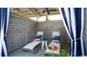 Relaxing cabana with lounge chairs, side table, and beachy decor at 771 St. Vincent Loop, Little River, SC 29566