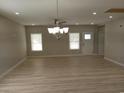 Bright living area featuring wood-look flooring, recessed lights, ceiling fan and elegant chandelier at 941 Hickman Rd., Tabor City, NC 28463