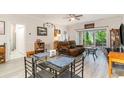 Bright living room area with a glass table set, opening to outdoor patio and well-lit seating area at 109 S Shore Blvd. # 104, Longs, SC 29568