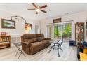Cozy living room featuring a plush sofa, ceiling fan, and sliding glass doors to the outside patio at 109 S Shore Blvd. # 104, Longs, SC 29568