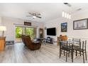 Living and dining area with modern lighting, ceiling fan, and access to patio with outdoor views at 109 S Shore Blvd. # 104, Longs, SC 29568