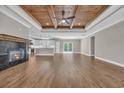 Stunning living room with a fireplace, wood ceiling, and hardwood floors flowing into the kitchen at 1151 Bear Lake Dr., Longs, SC 29568