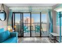 Living room showcasing blue accents and balcony access with ocean view at 2311 S Ocean Blvd. # 1125, Myrtle Beach, SC 29577