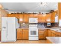 Kitchen boasts oak cabinets and white appliances at 305 21St Ave. S # 108, Myrtle Beach, SC 29577