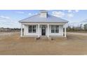 Newly constructed white cottage with metal roof and a spacious yard at 3368 Gurley Rd., Loris, SC 29569