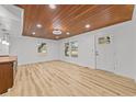 Bright living room with wood-look floors, white walls, and a wood plank ceiling at 447 Bragdon Ave., Georgetown, SC 29440