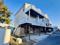 Charming raised beach home with a spacious covered area and staircase access at 6001 - 1045 S Kings Hwy., Myrtle Beach, SC 29575