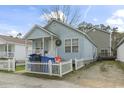 View of exterior featuring light blue vinyl siding, white trim, and well-maintained landscaping at 815 Rogers Dr., Myrtle Beach, SC 29577