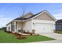 Craftsman style home with a two-car garage and landscaped yard at 1424 Turkey Oak Way, Longs, SC 29568