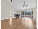 Spacious living room with a fireplace, ceiling fan, hardwood floors and sliding glass doors leading to the backyard at 158 Regency Dr., Conway, SC 29526