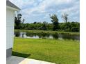 Scenic backyard with a serene pond view, lush greenery, and a peaceful, natural setting at 332 Hayloft Circle, Conway, SC 29526