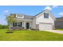 Attractive white home with blue shutters, a well-kept lawn, and a covered porch providing curb appeal at 332 Hayloft Circle, Conway, SC 29526