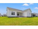 View of the rear of a home with a covered patio and ample yard space, perfect for outdoor enjoyment at 332 Hayloft Circle, Conway, SC 29526