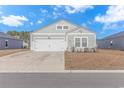 House exterior featuring a gray facade and a two-car garage at 624 Watercliff Dr., Longs, SC 29568