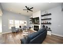Bright living room featuring wood floors, a stylish fireplace with floating shelves, and comfortable seating at 232 Deep Blue Dr., Myrtle Beach, SC 29579