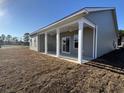 Covered back patio with columns, ceiling fans, and sliding glass doors for outdoor living at 301 Palmetto Sand Loop, Conway, SC 29527