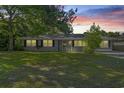Charming single-story home with well-maintained lawn and mature trees at sunset at 4502 Boxwood St., Myrtle Beach, SC 29577