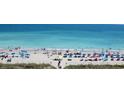 Beachside scene with beachgoers enjoying the sun, sand, and surf near the coastline at 4719 S Ocean Blvd. # 609, North Myrtle Beach, SC 29582