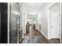Inviting hallway showcasing hardwood floors, a decorative front door, and neutral walls at 6550 Anterselva Dr., Myrtle Beach, SC 29572