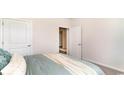 Simple bedroom with light walls, double door and a teal duvet at 179 Calm Dr., Little River, SC 29566