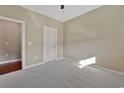 Neutral bedroom showcasing plush carpeting, a ceiling fan, and a white interior door at 2291 Heritage Loop, Myrtle Beach, SC 29577